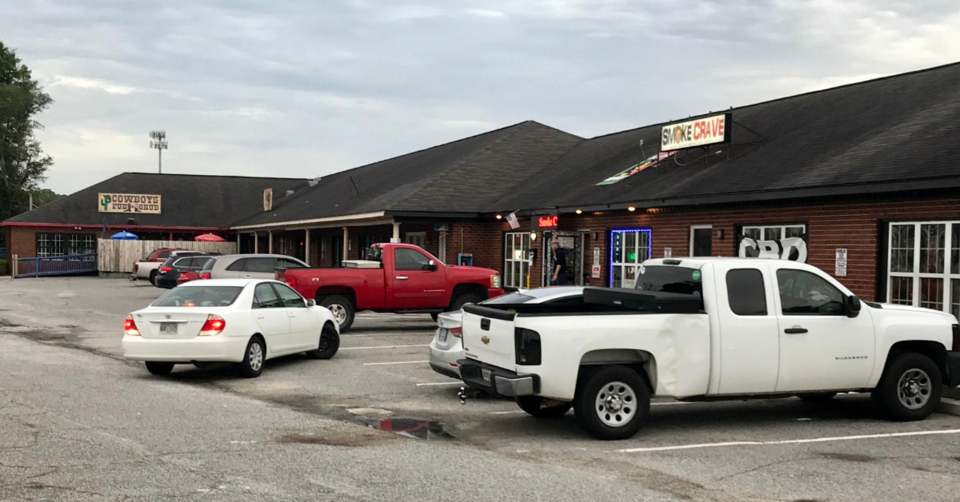 Commercial parking lot outside Cowboy’s Bar and Smoke Crave in Statesboro, Georgia, location of fatal gun violence involving Deontre Mincey.