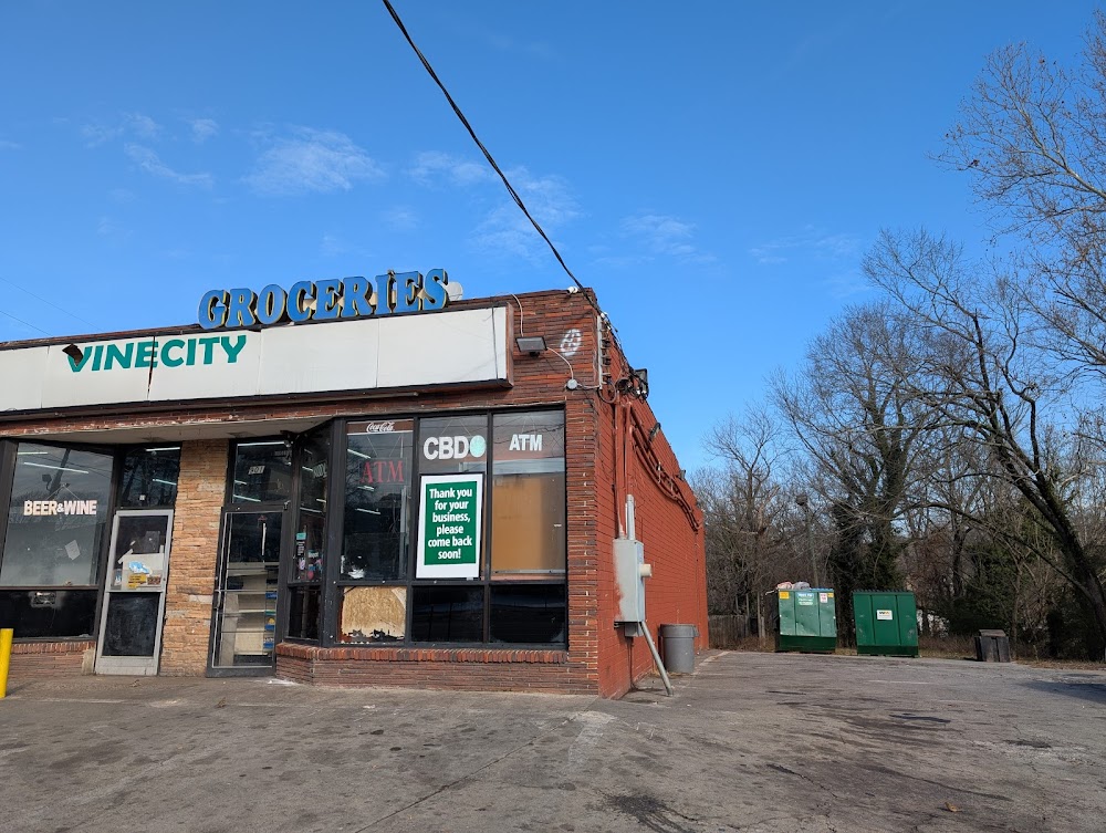 Exterior view of the Vine City food mart in Atlanta where a fatal shooting occurred, showing the storefront and parking area.