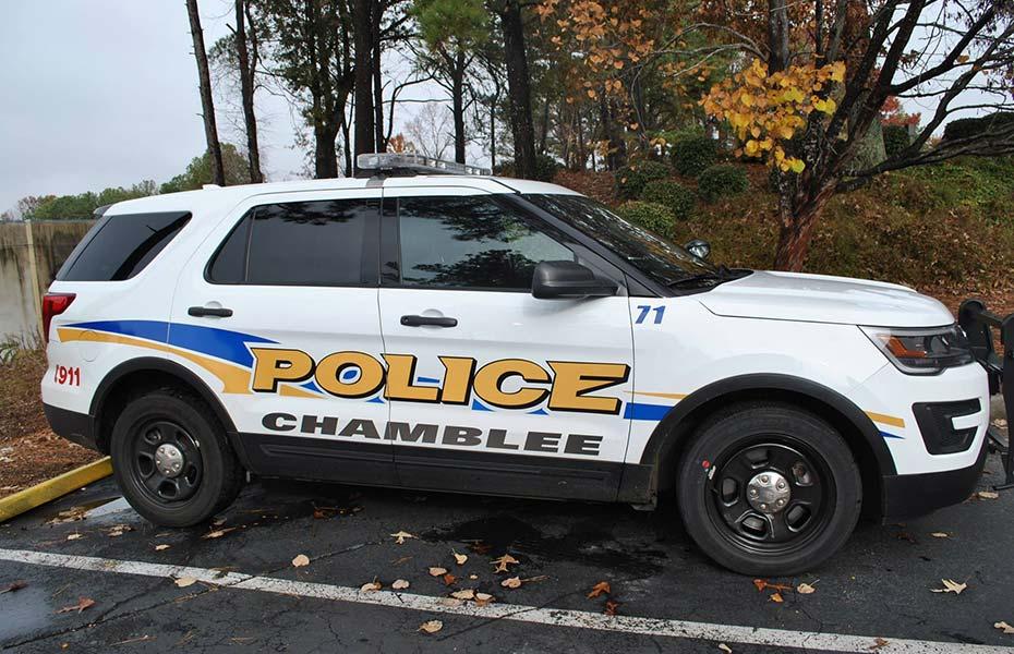 A white Chamblee Police Ford Explorer SUV patrol vehicle parked in a parking lot.