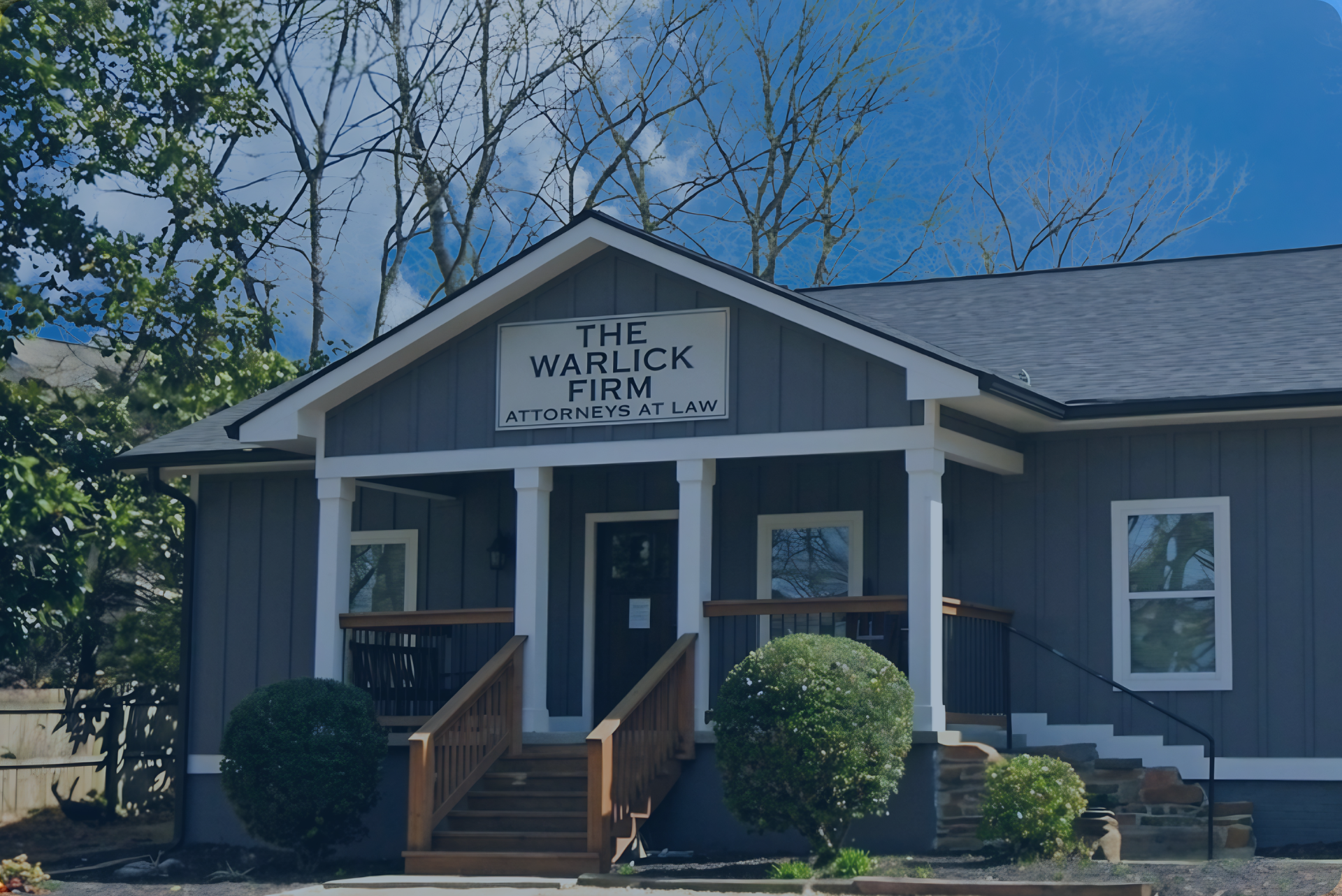 Exterior view of The Warlick Firm Law office in Woodstock Georgia, featuring a dark blue overlay.
