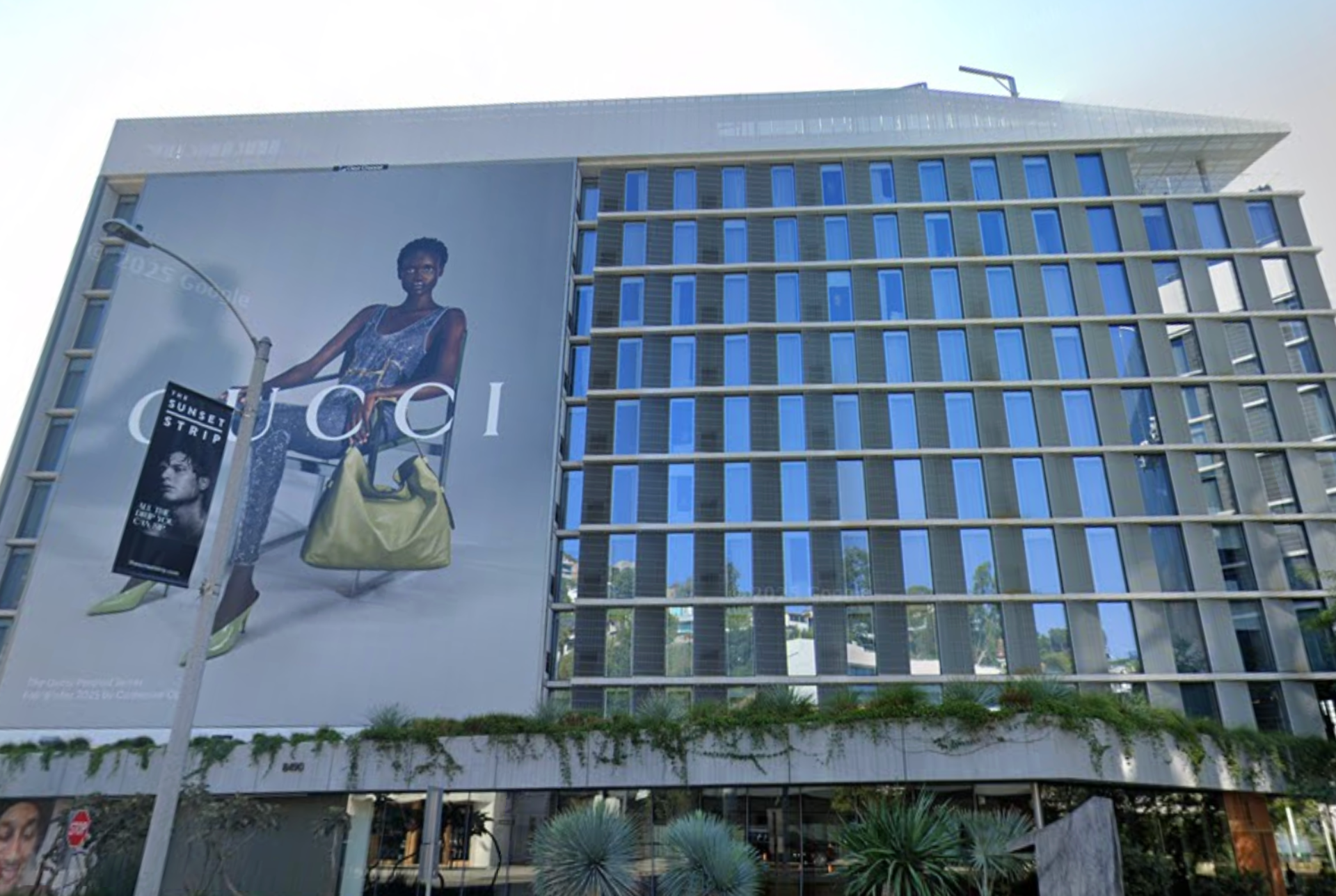 Exterior view of 1 Hotel West Hollywood featuring a large modern glass facade and Gucci billboard. Man Shot in the Leg at West Hollywood Hotel Rooftop: What Are the Legal Options for Victims and Families?